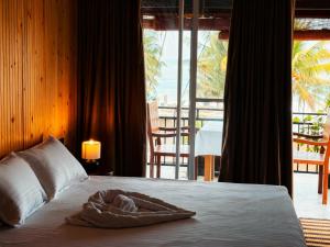 a hotel room with a bed with a towel on it at Kumarana in Bentota
