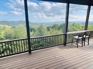 a balcony with a bench and a view of the mountains at Sugar Mountain Condo, Sleep 4, Deck Mountain Views in Sugar Mountain