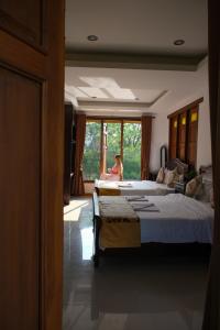 a woman sitting on a bed in a bedroom at Romantic Vang Vieng resort in Vang Vieng +25 photos