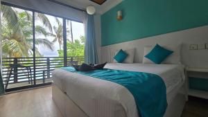 a bedroom with a bed and a large window at The Pearl Seaview in Fulidhoo