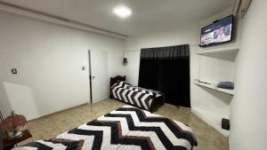 a living room with a couch and a television on a wall at Soles del Boulevard in Córdoba