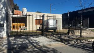 a fence with a van parked in front of a building at Soles del Boulevard in Córdoba