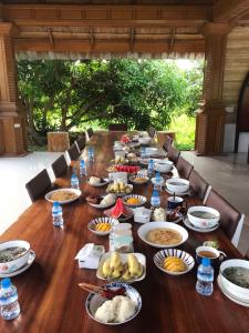 a long table full of food on a table at Romantic Vang Vieng resort in Vang Vieng