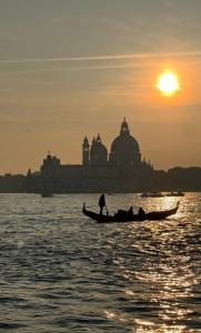 two people in a boat in the water at sunset at CASA BANON in Venice