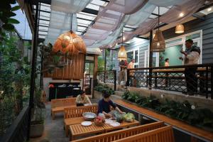 a restaurant with two people sitting at a table at AP HOME - Lakeside in Ấp Ðinh An (1)