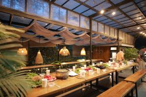 a restaurant with a long table filled with food at AP HOME - Lakeside in Ấp Ðinh An (1)