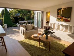a living room with a couch and a table at Sublime Luxury - Battery Point in Hobart