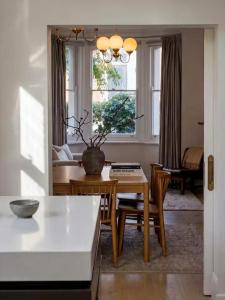 a living room with a table and chairs and a couch at Sublime Luxury - Battery Point in Hobart