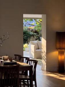 a living room with a table and chairs and a couch at Sublime Luxury - Battery Point in Hobart