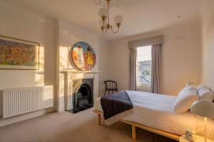 a bedroom with a large bed and a fireplace at Sublime Luxury - Battery Point in Hobart +29 photos
