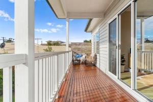 a balcony with a view of a house at San Remo Bay Views Phillip Island Gateway in San Remo
