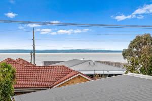a view of roofs of houses and a body of water at San Remo Bay Views Phillip Island Gateway in San Remo