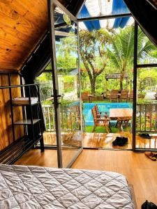 a bedroom with a balcony with a table and a bench at Dak Nguyen Homestay DakLak in Buon Ma Thuot
