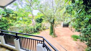 a balcony with a view of a yard at Thuru Sisila Resort in Anuradhapura