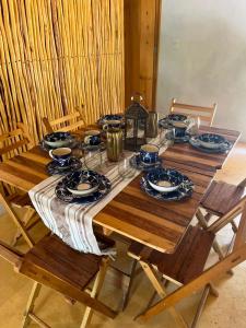 a wooden table with plates of food on it at Eco Hacienda ICH-KI in Hoctún
