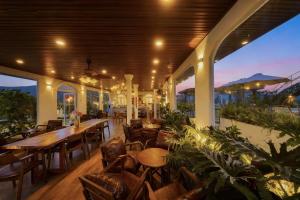 a restaurant with tables and chairs and a large room at Chanchill Glamping&cafe in Xuân Thọ