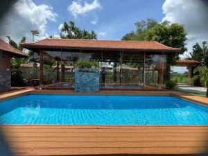 a swimming pool with a gazebo at Melalueca tay ninh in Tây Ninh