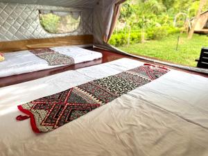 a bed in a tent with a rug on it at Hen Camping- Coffee --------- Free if you have tent in Ninh Binh