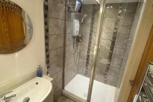 a bathroom with a shower and a toilet and a sink at Studio sleeps 2 with Parking in Derby