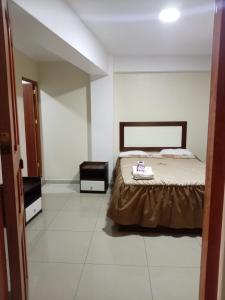 a bedroom with a bed and two night stands at Perú Andina Tours & Hostel Amparo in Huaraz +23 photos