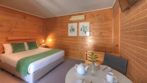 a bedroom with a bed and a table in a room at Paruna Motel in Swan Hill