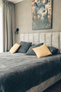 a bedroom with a bed with a picture of a cow on the wall at Brīvdienu māja Daugavas rezidence in Ķegums