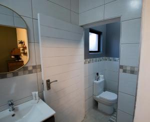 a bathroom with a toilet and a sink at Weavers Nest Guesthouse in Modimolle +11 photos
