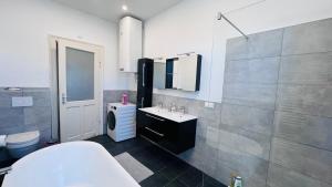 a bathroom with a sink and a toilet at Junior Suite Apartment Eleven in Graz +38 photos