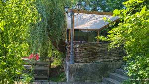 a house with a porch with stairs and a street light at Guest House Dacha in Kyiv