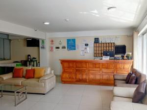 a waiting room with two couches and a counter at Perú Andina Tours & Hostel Amparo in Huaraz