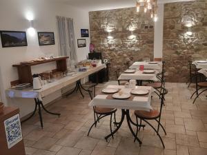 a restaurant with tables and chairs in a room at Locanda Cà de Rusitta in Vezzi Portio +16 photos