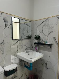 a bathroom with a sink and a mirror at Khaosok Diary Camp in Khao Sok National Park +55 photos