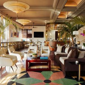 a living room with couches and a table at The Betsy Hotel, South Beach in Miami Beach