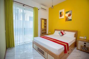 a bedroom with a bed and a yellow wall at Lovina Heights in Mount Lavinia +73 photos