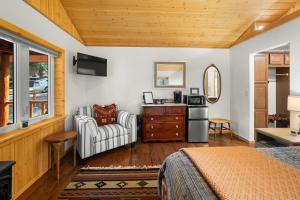 a bedroom with a bed and a chair and a dresser at Moose Hollow Studio Cabin in Eureka