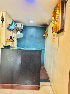 a kitchen with a black counter and a blue wall at Hotel Laxmi in Hinjewadi +16 photos