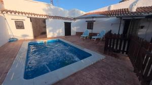 a swimming pool on a patio next to a house at Cuevas Padre Poveda in Guadix
