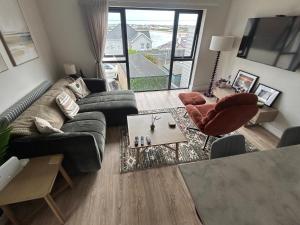 a living room with a couch and a table at Blackhill Lookout in Portrush