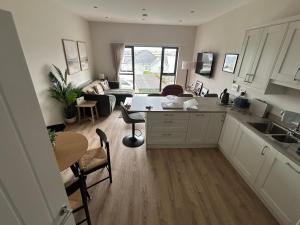 a kitchen and living room with a table and chairs at Blackhill Lookout in Portrush