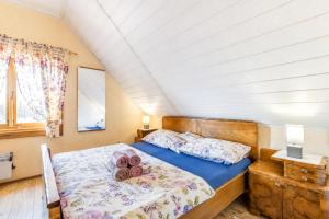 a bedroom with a bed with two pillows on it at Rustic Cottage With Heated Pool - Happy Rentals in Velika Buna