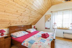 a bedroom with a bed in a wooden room at Rustic Cottage With Heated Pool - Happy Rentals in Velika Buna
