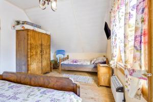 a bedroom with a bed and a bunk bed at Rustic Cottage With Heated Pool - Happy Rentals in Velika Buna