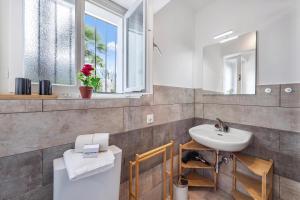 a bathroom with a sink and a toilet at Residenza La Serenata in Cavigliano