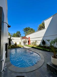 a swimming pool in the courtyard of a house at Royal Classic Puncak in Cisarua