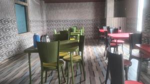 a row of chairs and tables in a restaurant at Vibgyor Hotel in Cherrapunji