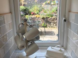 a group of hair driers sitting in front of a window at 3 Lowerbourne Terrace in Minehead +30 photos