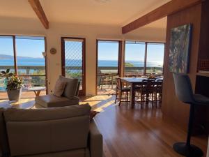 a living room with a couch and a table at Lorne Beach House in Lorne