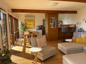 a living room with a couch and a table at Lorne Beach House in Lorne