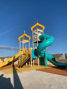 a playground with a slide in a park at La Gata Negraa in Bácor