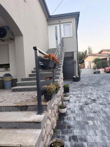 a house with a staircase with potted plants on it at Haus EL MILO in Jadranovo